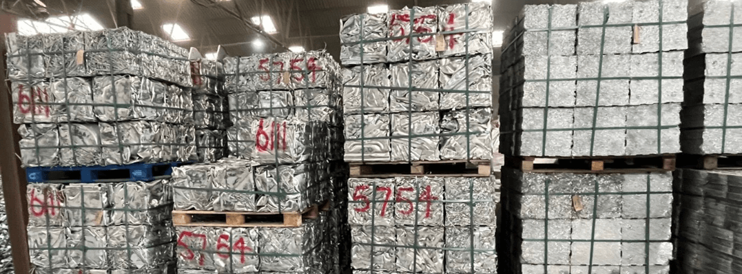 Aluminium stacked on pallets in a warehouse